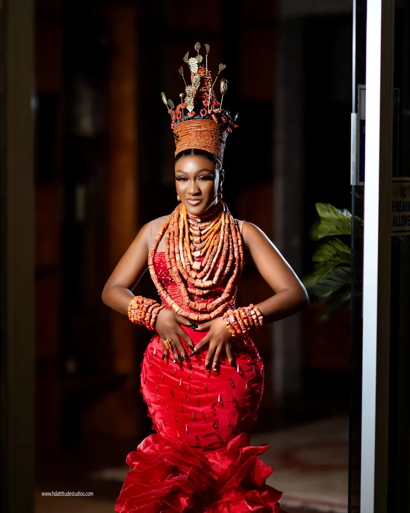 Coral-crowned bride close-up, smiling, layered coral necklaces